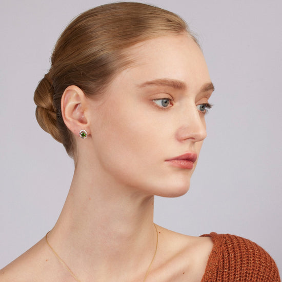 Woman wearing a brown knitted sweater with a plain background
