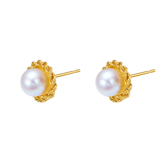Pair of pearl earrings with gold settings on a white background