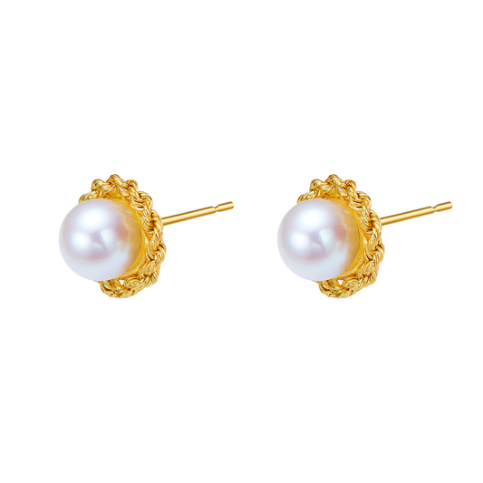 Pair of pearl earrings with gold settings on a white background