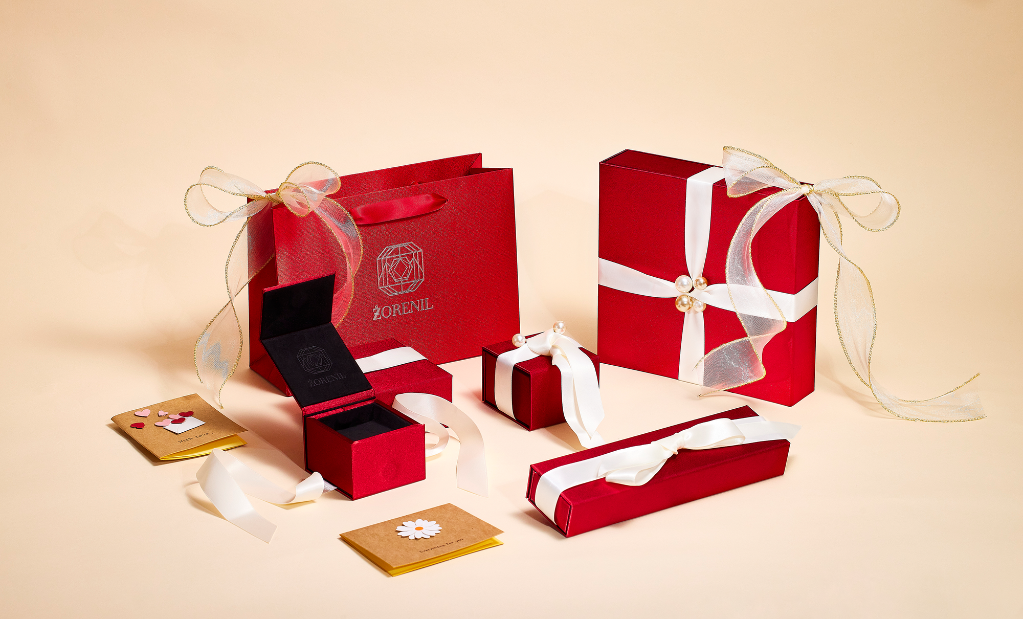 Red jewelry box with accessories on a beige background