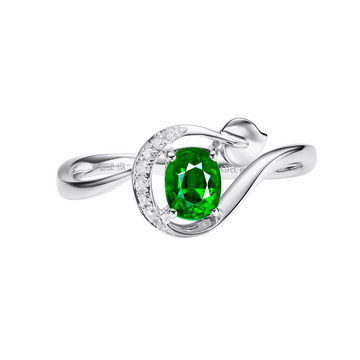 Silver ring with a green gemstone on a white background