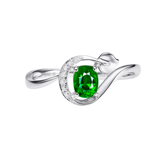 Silver ring with a green gemstone on a white background