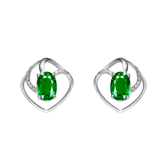 Heart-shaped earrings with green gemstones on a white background