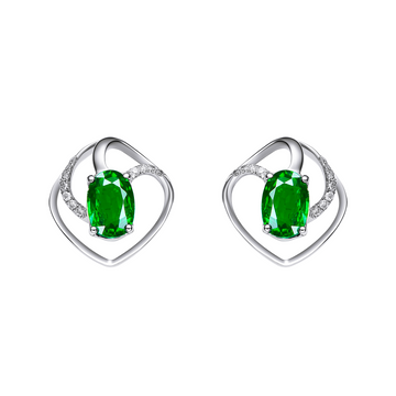 Heart-shaped earrings with green gemstones on a white background