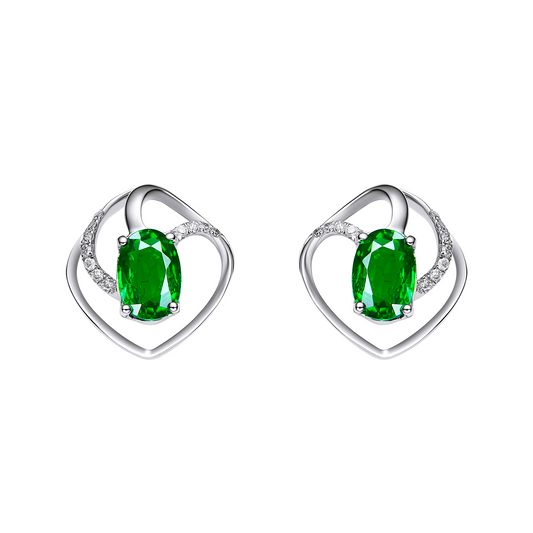 Heart-shaped earrings with green gemstones on a white background