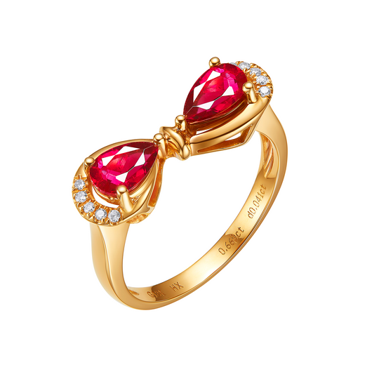 Gold ring with two red gemstones and diamond accents on a white background