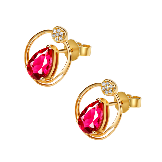 Gold earrings with red gemstones on a white background