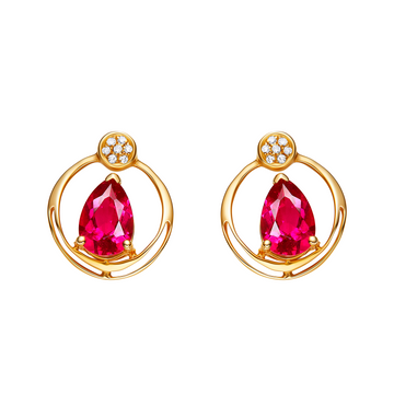 Gold earrings with red gemstones on a white background