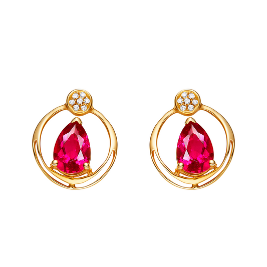 Gold earrings with red gemstones on a white background