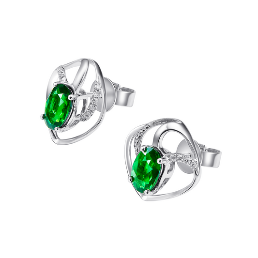 Silver earrings with green gemstones on a white background