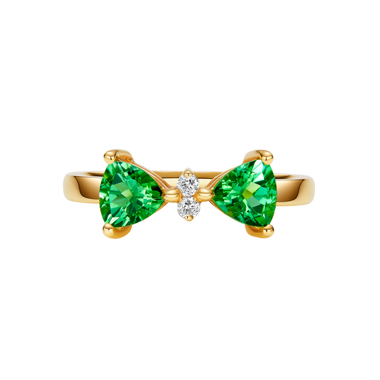 Gold ring with green gemstones on a white background