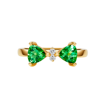 Gold ring with green gemstones on a white background