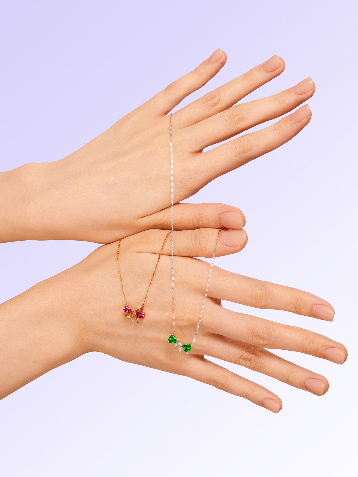 Two hands wearing necklaces with small beads on a light purple background