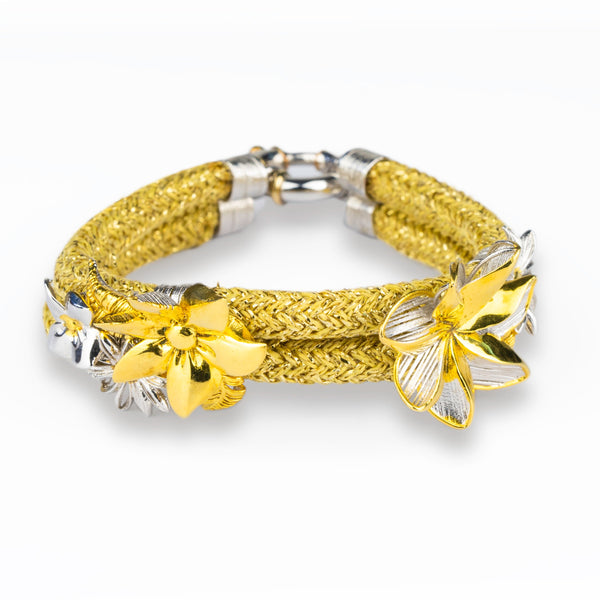 Yellow braided bracelet with silver and gold accents on a white background