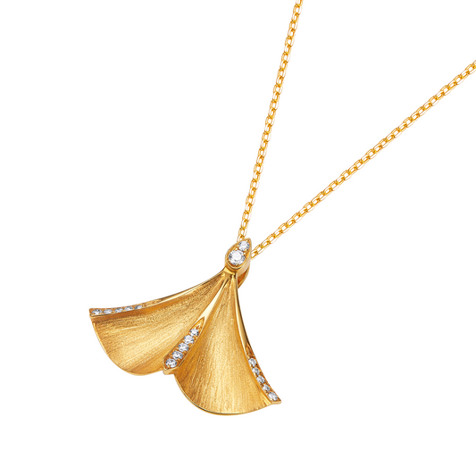 Gold necklace with a leaf-shaped pendant on a white background