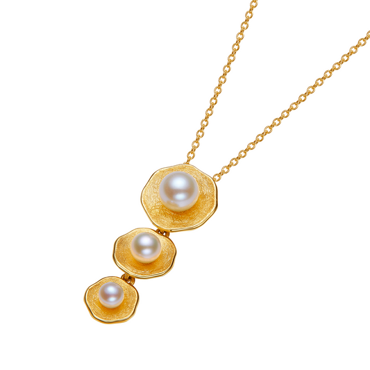 Gold necklace with three pearls on a white background