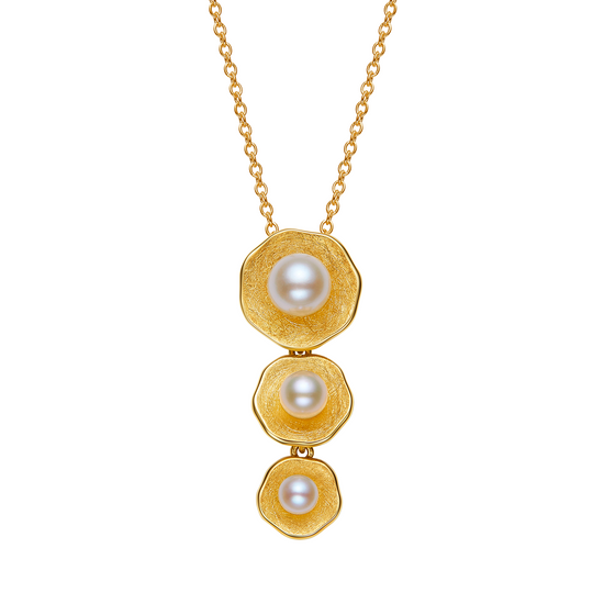 Gold necklace with three pearl pendants on a white background